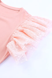 Blush pink ribbed knit blouse with sheer polka dot tulle ruffle sleeves.