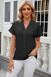 Black textured V-neck blouse with rolled short sleeves and a relaxed fit.
