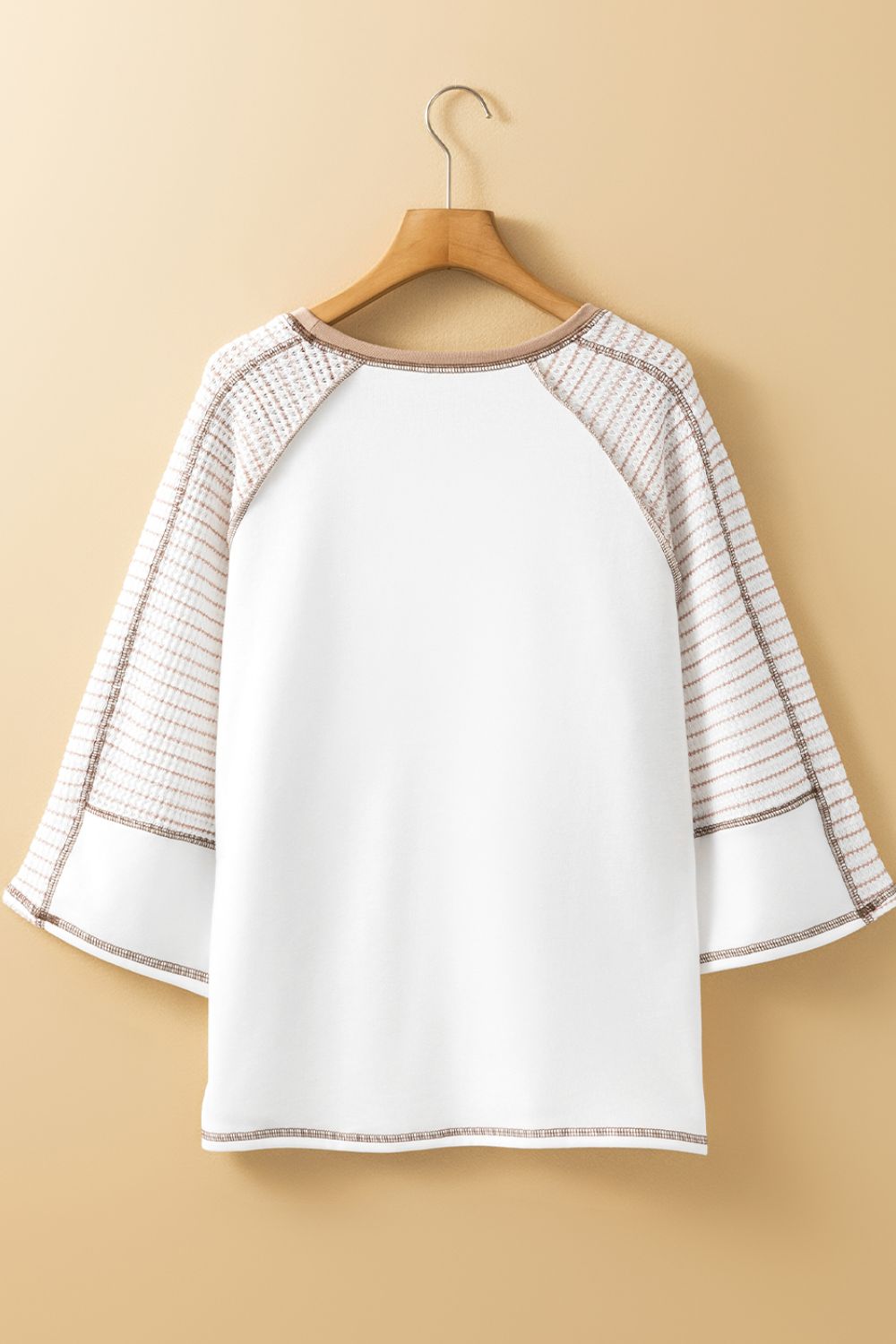 Textured raglan sleeve tee in white with a subtle plaid pattern on the sleeves.