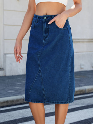 Panel-seam denim midi skirt in dark blue with front pockets and a button closure.