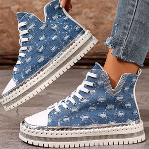 Blue denim high-top sneakers with rhinestone embellishments and a chunky sole.