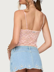 Blush pink lace cami with adjustable straps and floral pattern.