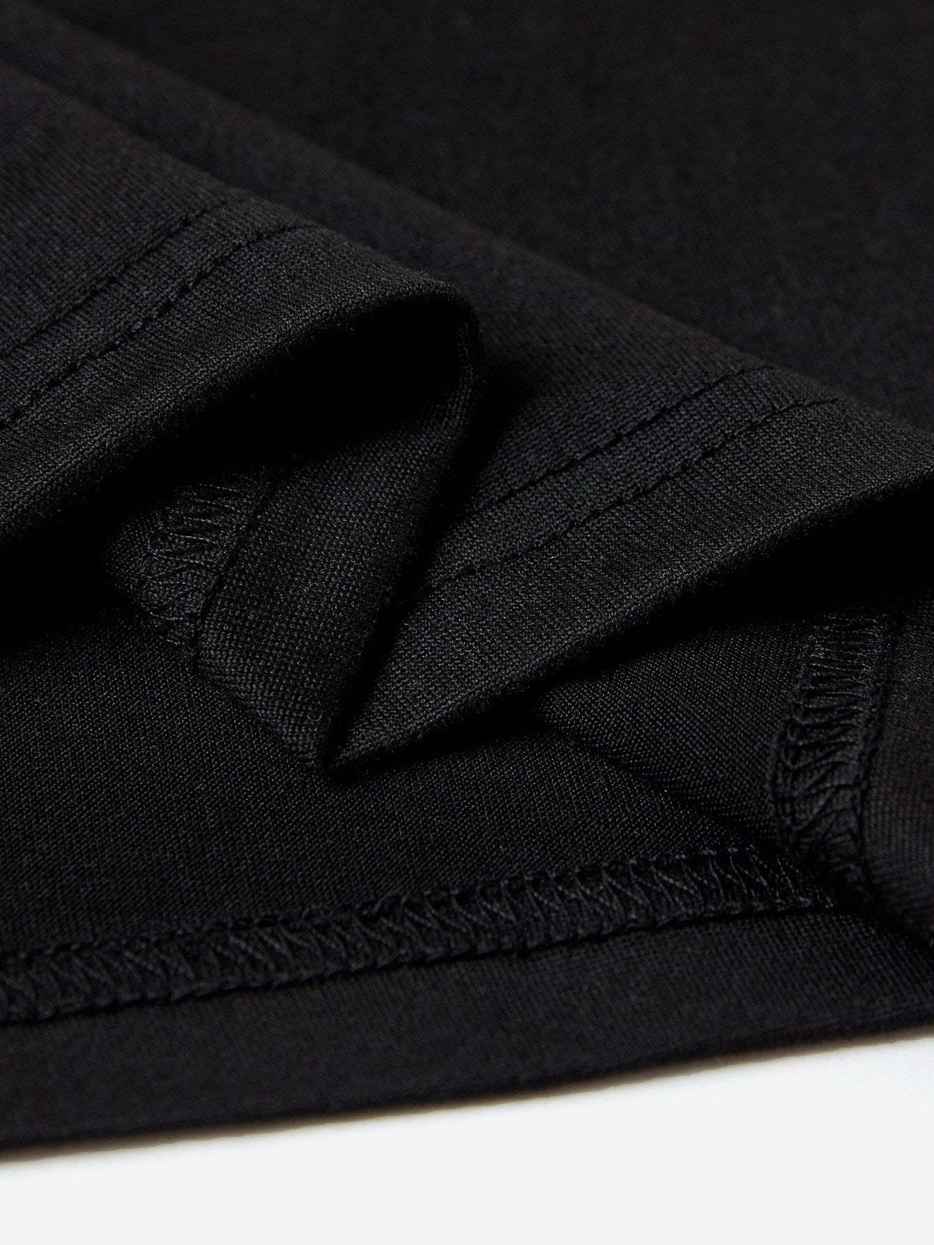 Black graphic tee showing fabric texture and stitching detail