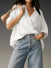 White V-neck half sleeve shirt with a relaxed fit, styled with jeans.