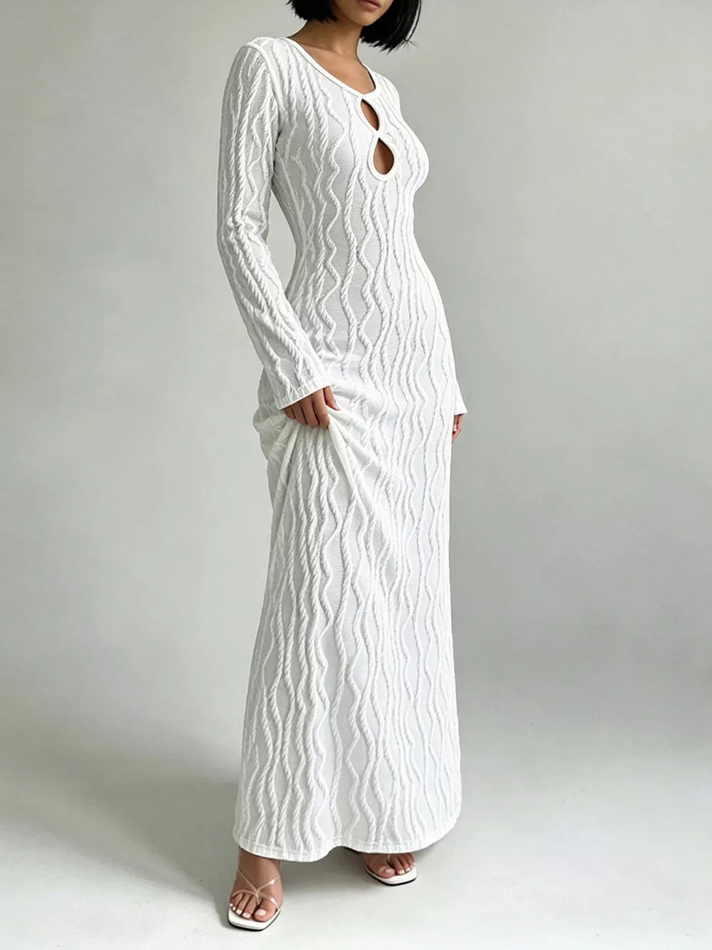 White textured long sleeve maxi dress with cutout neckline and bodycon fit.