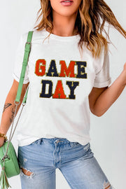 White graphic tee with sequin-trimmed GAME DAY lettering, crew neck, short sleeves.