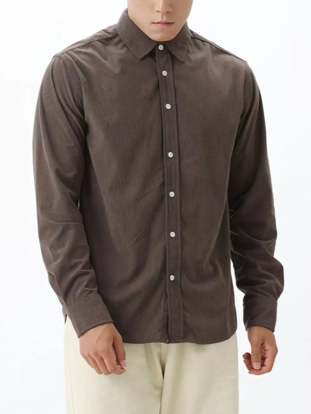 Brown corduroy long sleeve buttoned shirt with a spread collar.