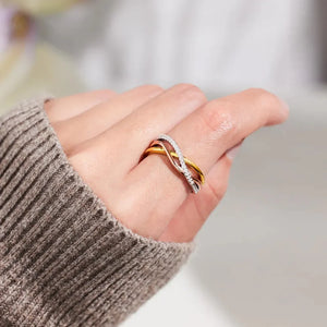 Intertwined trio diamond ring in gold-plated metal with sparkling white stones.