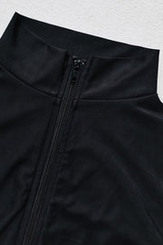 Black sporty legging swimsuit with zip detail and high neckline.