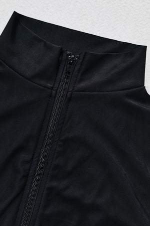 Black sporty legging swimsuit with zip detail and high neckline.