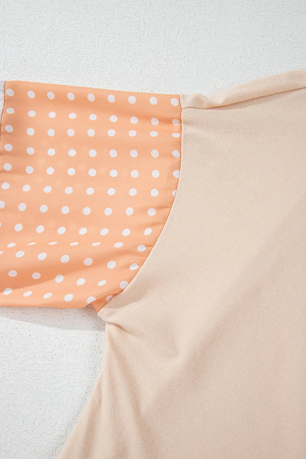 Patchwork sleeve blouse in Dust Storm with white polka dots on peach fabric.