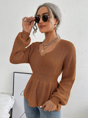 Caramel peplum knit sweater with scallop neckline and long sleeves.