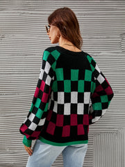 Black knit sweater with checkerboard pattern, puff sleeves, and crew neck.