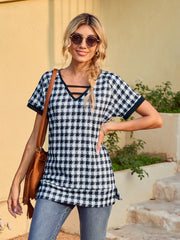 Houndstooth tunic top with cutout neckline and short sleeves, in dark blue.