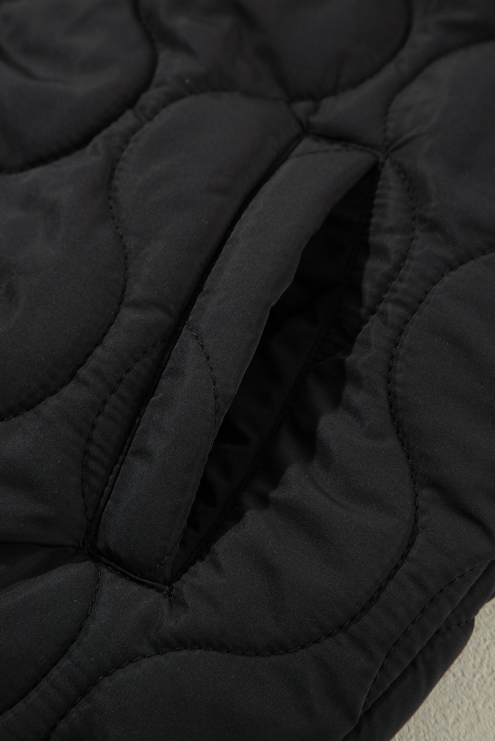 Black quilted hooded sleeveless jacket with a pocket detail