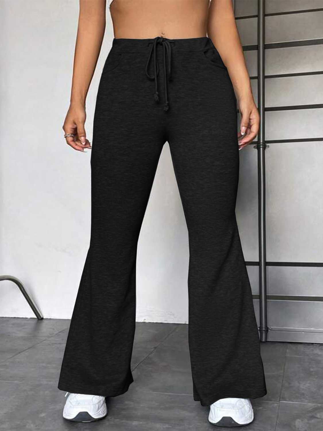 Black flare leg lounge trousers with drawstring waist and pockets.