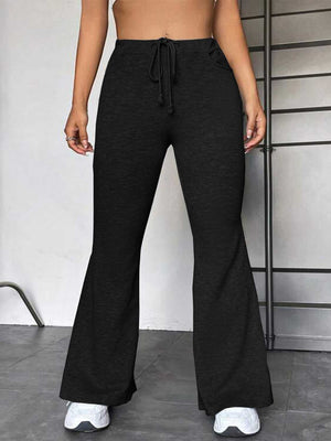 Black flare leg lounge trousers with drawstring waist and pockets.