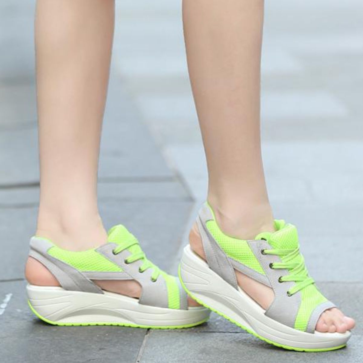 Sporty lace-up wedge sandals in lime green and gray with breathable mesh and cutouts.