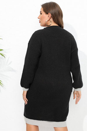 Black ribbed knit dress with contrast trim on sleeves and hem.