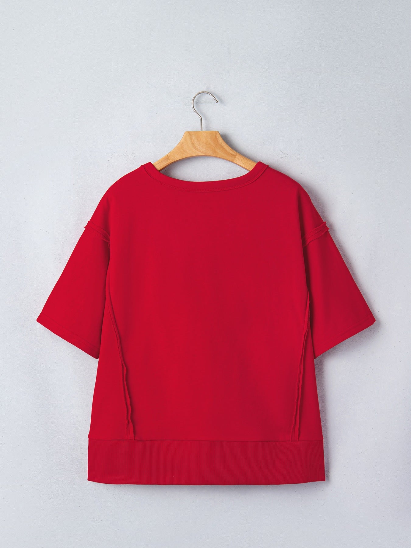 Red cotton blend drop shoulder tee with short sleeves and a banded hem.