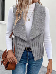 Gray textured teddy collarless vest with ribbed knit body and open front.
