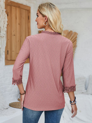 Dusty pink eyelet blouse with lace trim on neckline and sleeves.