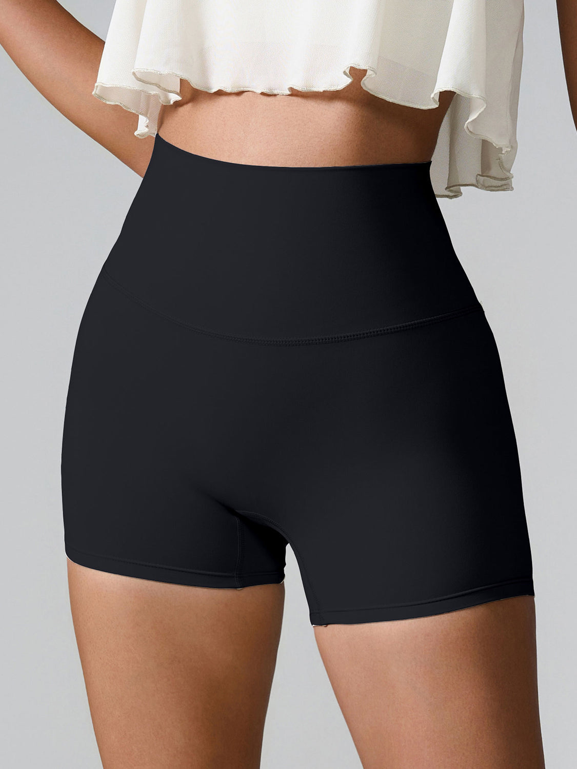 Black high-waisted active shorts with sculpted pocket detail