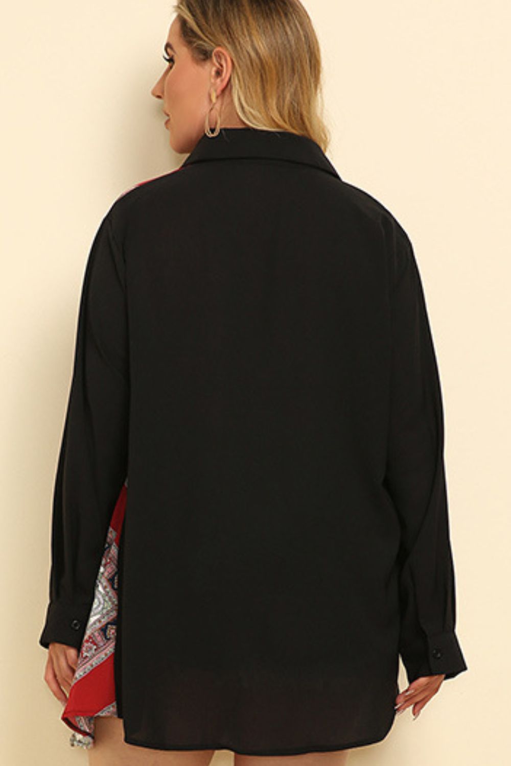 Black shirt dress with asymmetric paisley panel detail and buttoned cuffs.