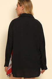 Black shirt dress with asymmetric paisley panel detail and buttoned cuffs.