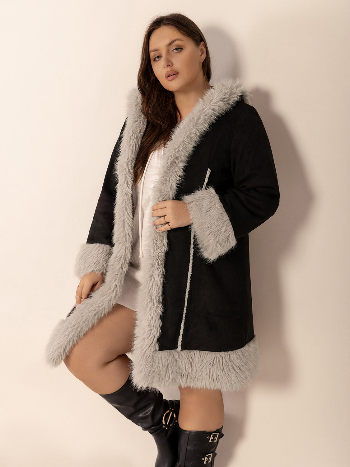 Black hooded duster coat with faux shearling trim and lining.