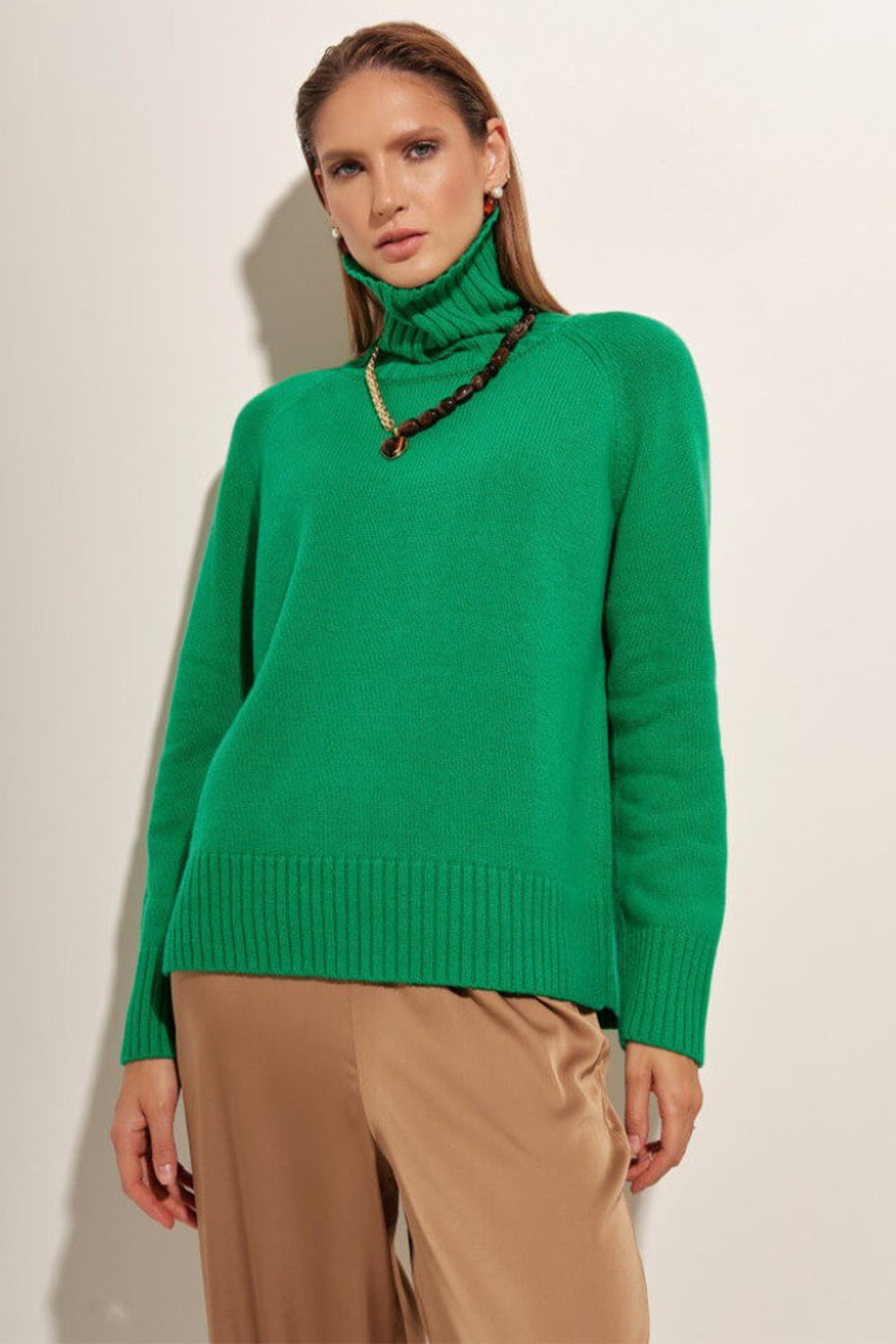 Mid Green cashmere turtleneck sweater with raglan sleeves and ribbed cuffs and hem.