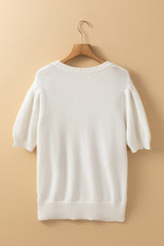 White cable knit sweater with puff sleeves and crew neck