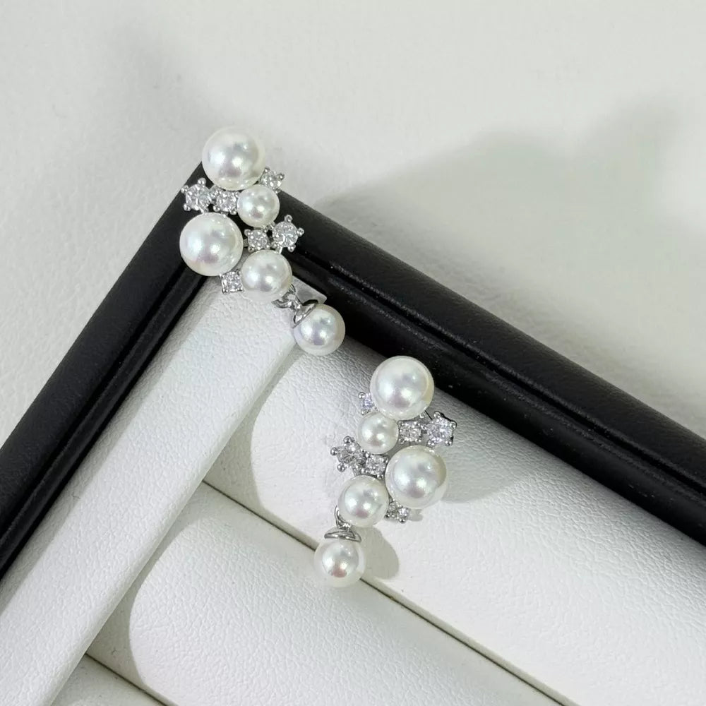 White pearl and zircon cluster earrings with silver accents.