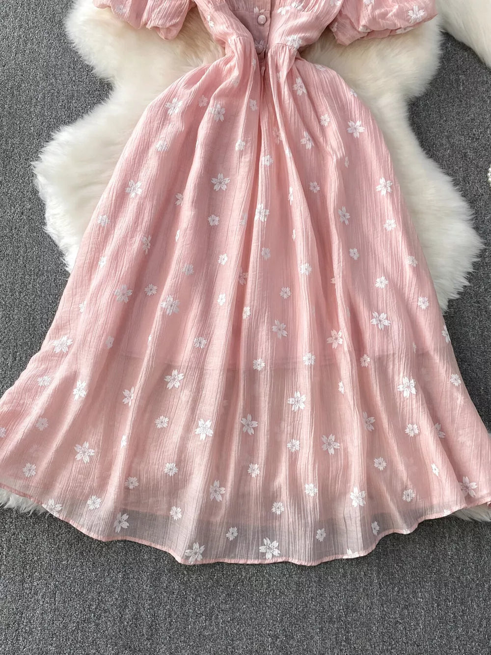 Dusty pink midi dress with puff sleeves, button front, and white floral embroidery.