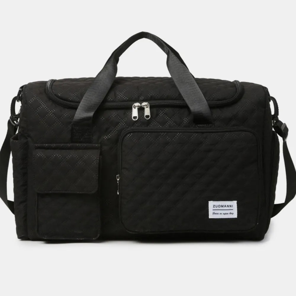 Black quilted duffel bag with olive accents, dual handles, and multiple pockets.