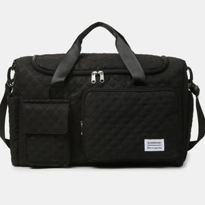 Black quilted duffel bag with olive accents, dual handles, and multiple pockets.