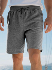 Men's dark gray casual shorts with drawstring waist and zip pocket detail.