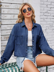 Cropped denim blouson jacket in light blue with button front and chest pockets.
