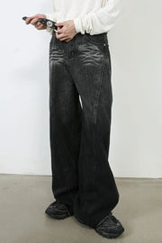Dark denim palazzo trousers with a wide leg and subtle whiskering detail.
