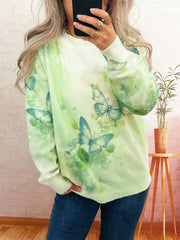 Lightweight knit sweater with allover green watercolor butterfly print and crystal details.