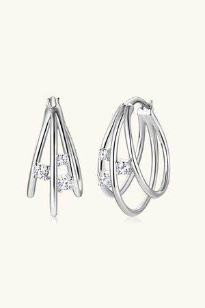 Silver hoop earrings with diamond accents and a sculptural design.