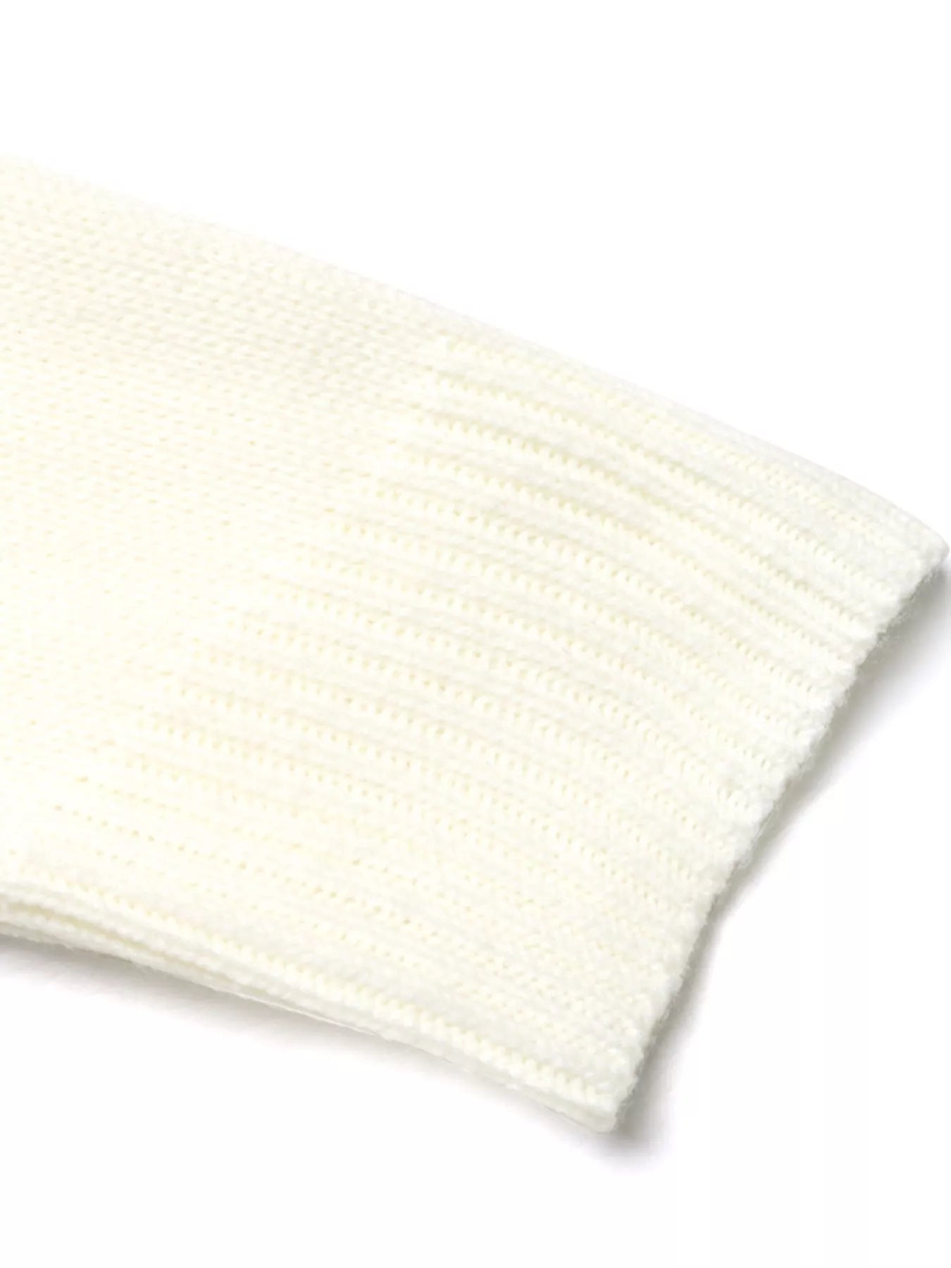 White acrylic knit long-sleeve sweater detail showing ribbed texture