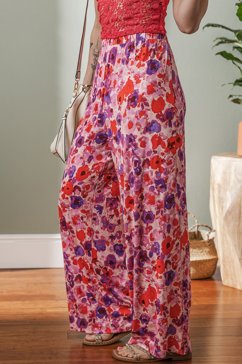 Painterly floral palazzo trousers in strawberry pink with wide legs and a comfortable fit.