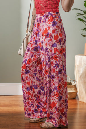 Painterly floral palazzo trousers in strawberry pink with wide legs and a comfortable fit.