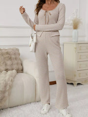 Tied two-piece set in apricot stripes with a tie-neck long sleeve top and flared pants.