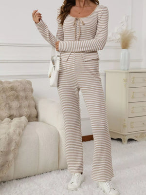 Tied two-piece set in apricot stripes with a tie-neck long sleeve top and flared pants.
