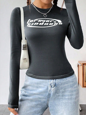 Dark gray long sleeve fitted graphic top with white contrast stitching and a white oval logo.