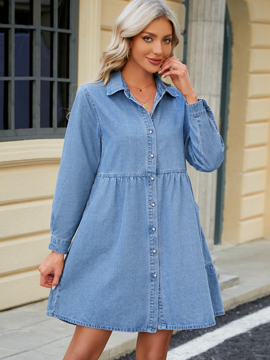 Tiered denim shirtdress in medium blue with button front, collar, and gathered waist.