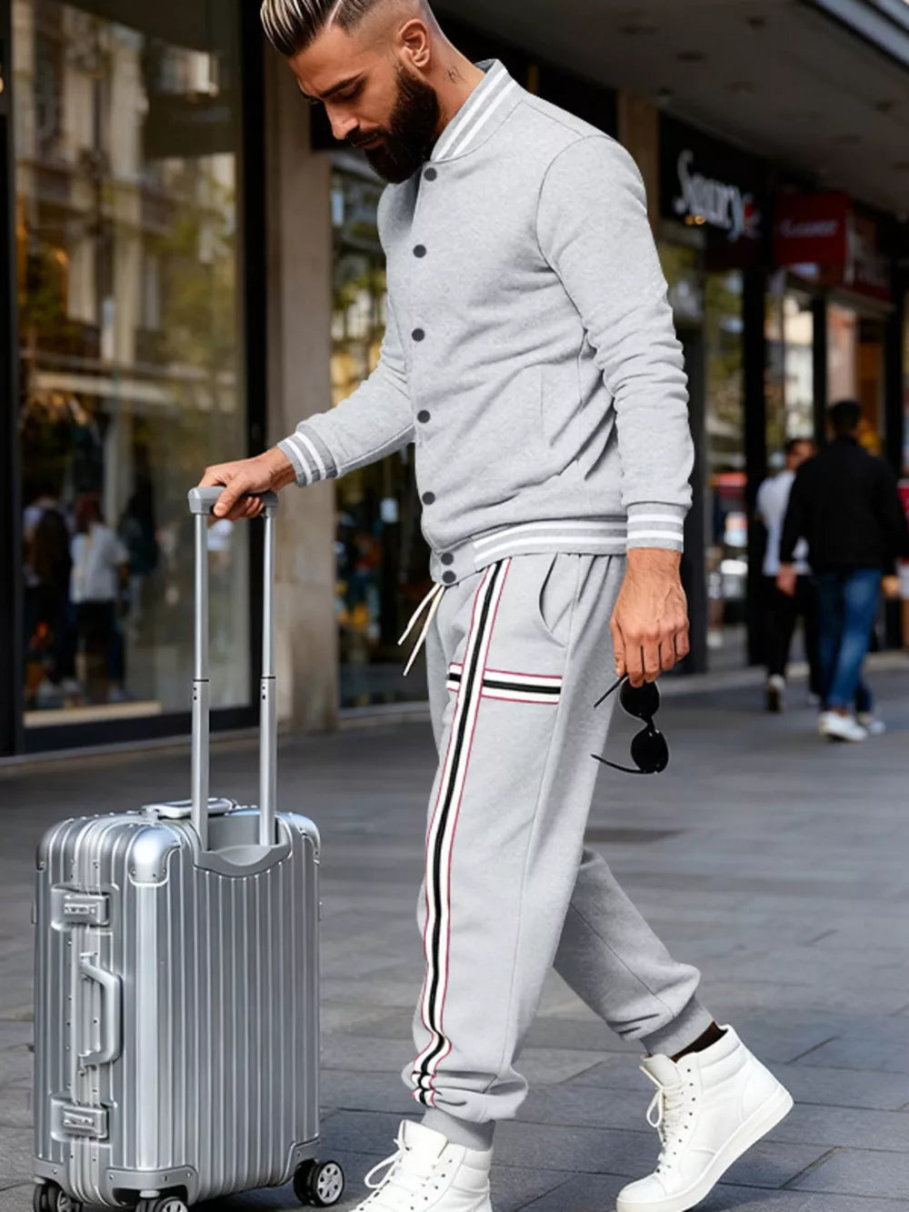 Men's light gray tracksuit set with striped details on jacket sleeves and pants.