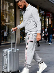 Men's light gray tracksuit set with striped details on jacket sleeves and pants.